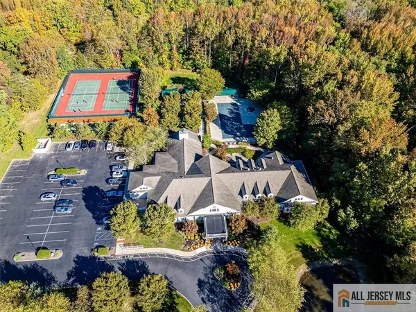an aerial view of a house with a yard and garden