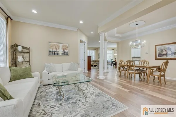 a living room with furniture and a dining table