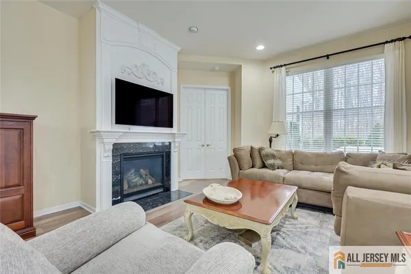 a living room with furniture a fireplace and a flat screen tv