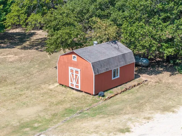 a wooden bench sitting in the middle of a yard