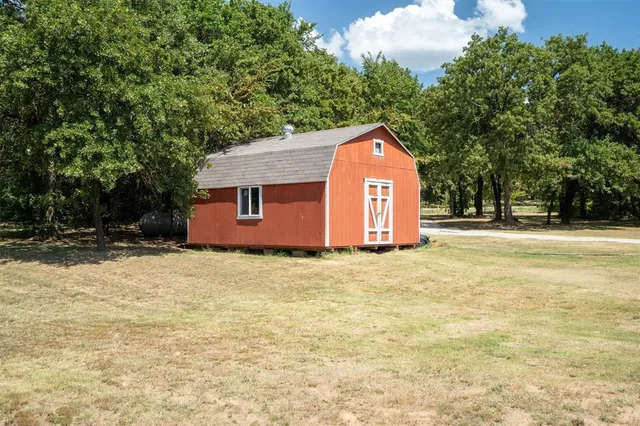 a view of backyard of house with green space