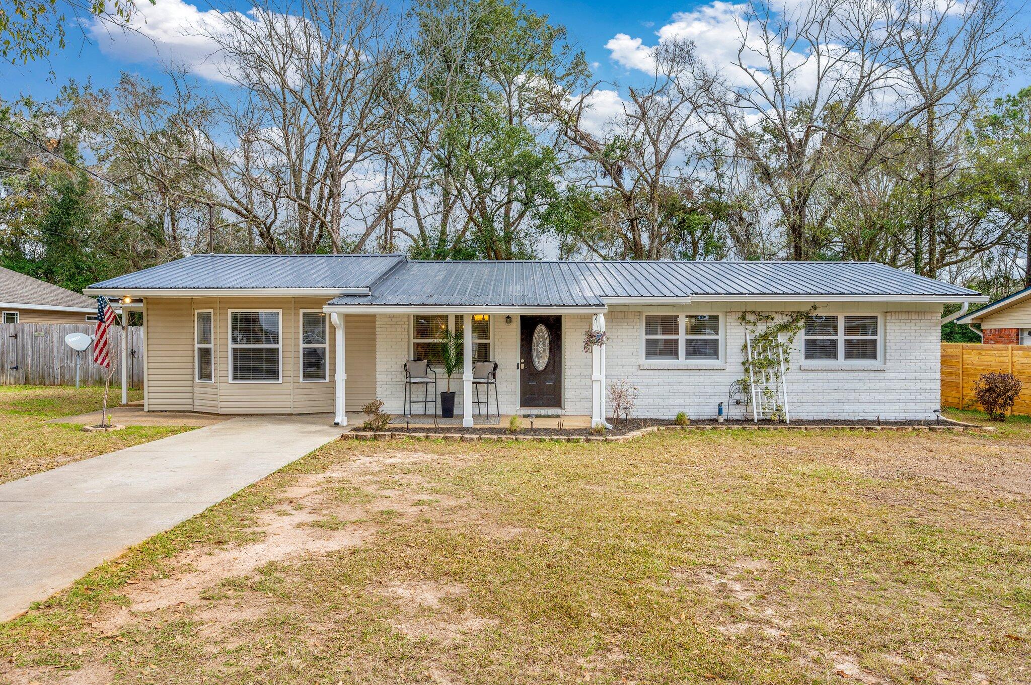 149 Shady Lane Crestview, FL 32536 - Photo 1 of 50 a front view of a house with a garden