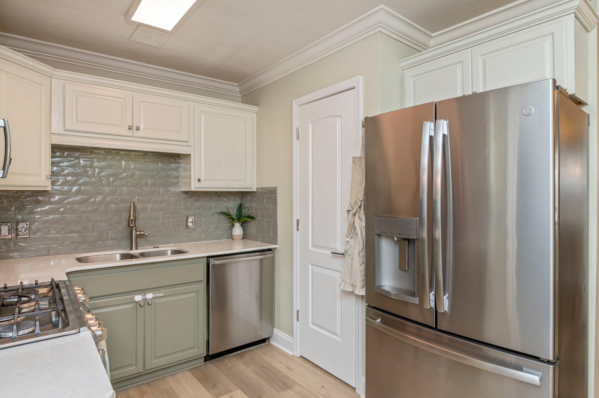 149 Shady Lane Crestview, FL 32536 - Photo 11 of 50 a kitchen with stainless steel appliances a refrigerator sink and cabinets