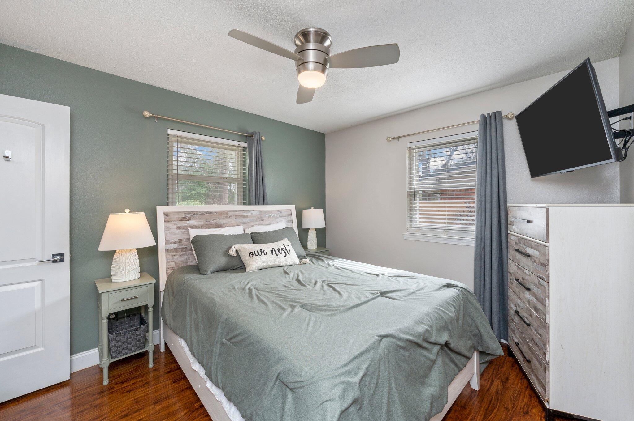 149 Shady Lane Crestview, FL 32536 - Photo 35 of 50 a bedroom with a bed a flat screen tv and a chandelier