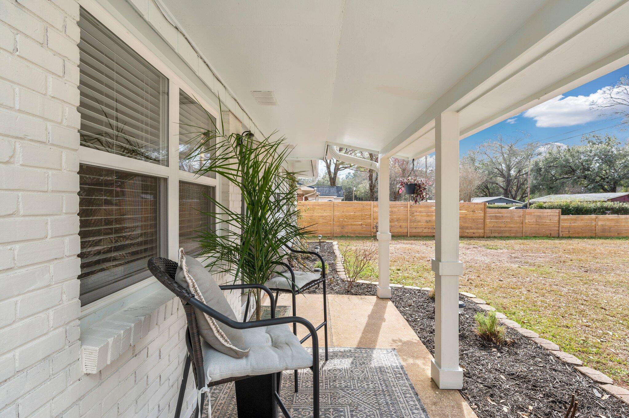 149 Shady Lane Crestview, FL 32536 - Photo 6 of 50 a porch with a table and chairs and potted plants