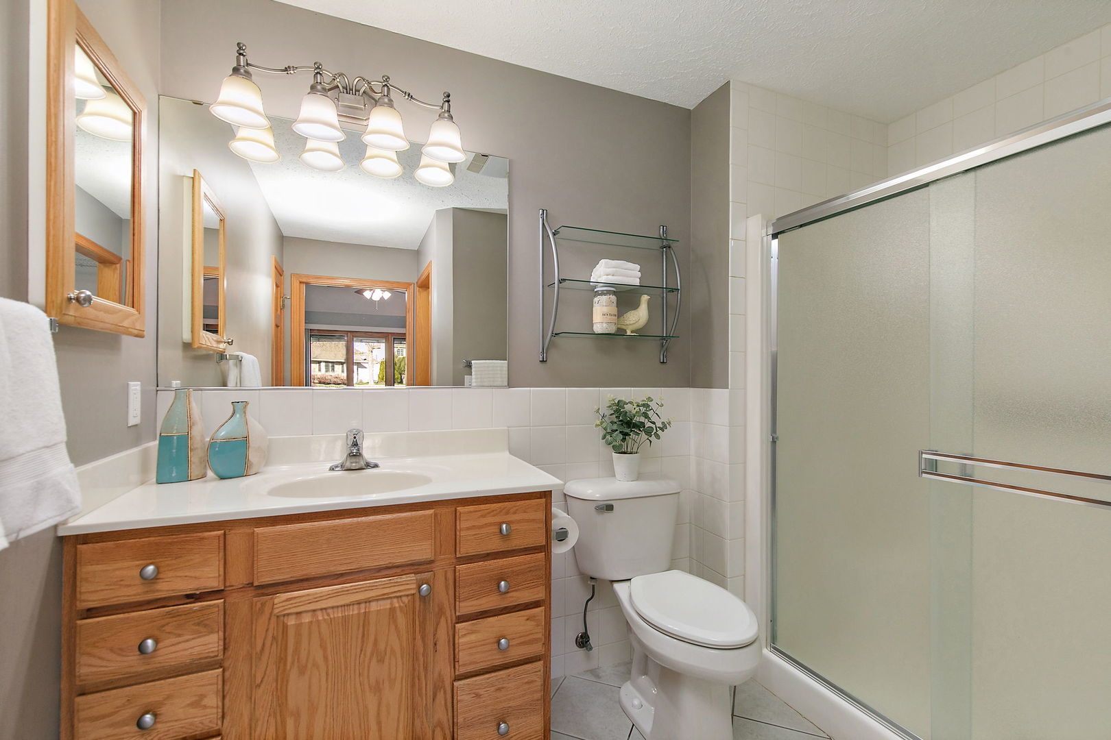 543 Brant Circle DeKalb, IL 60115 - Photo 15 of 28 a bathroom with a granite countertop sink toilet a large mirror and shower