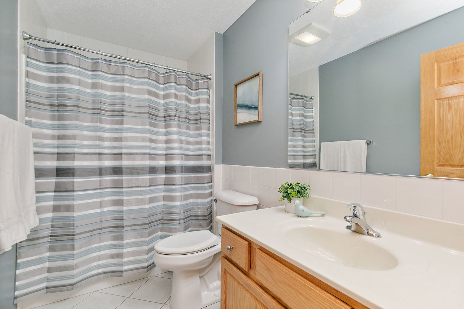 543 Brant Circle DeKalb, IL 60115 - Photo 18 of 28 a bathroom with a sink a toilet and shower curtain