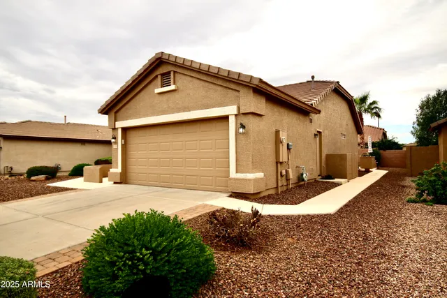a front view of a house with garden
