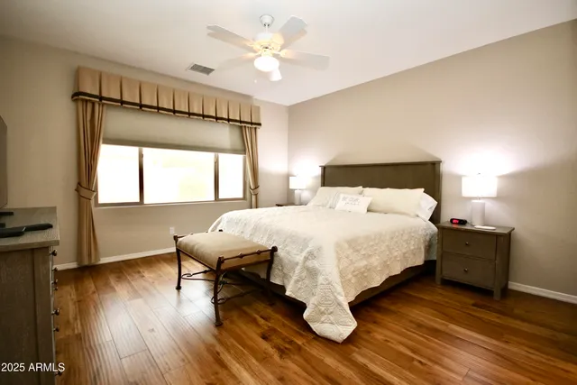 a bedroom with a bed and a chandelier