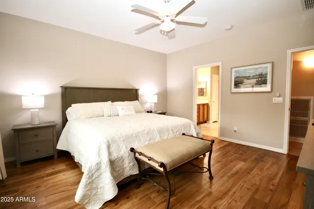 a bedroom with a bed and wooden floor
