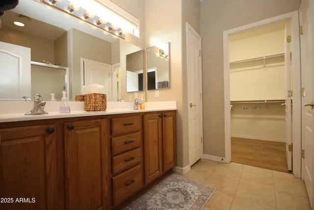 a bathroom with a double vanity sink and a mirror