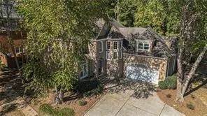 a view of house with a yard