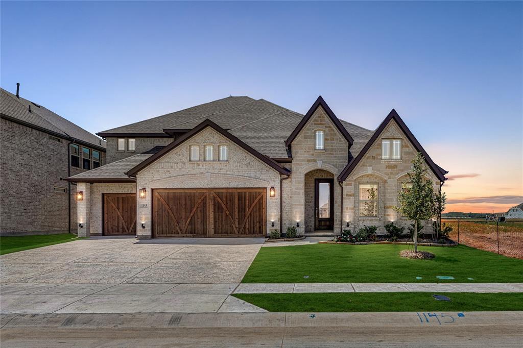 1145 Hitching Post Way Oak Point, TX 75068 - Photo 2 of 39 a front view of a house with a yard