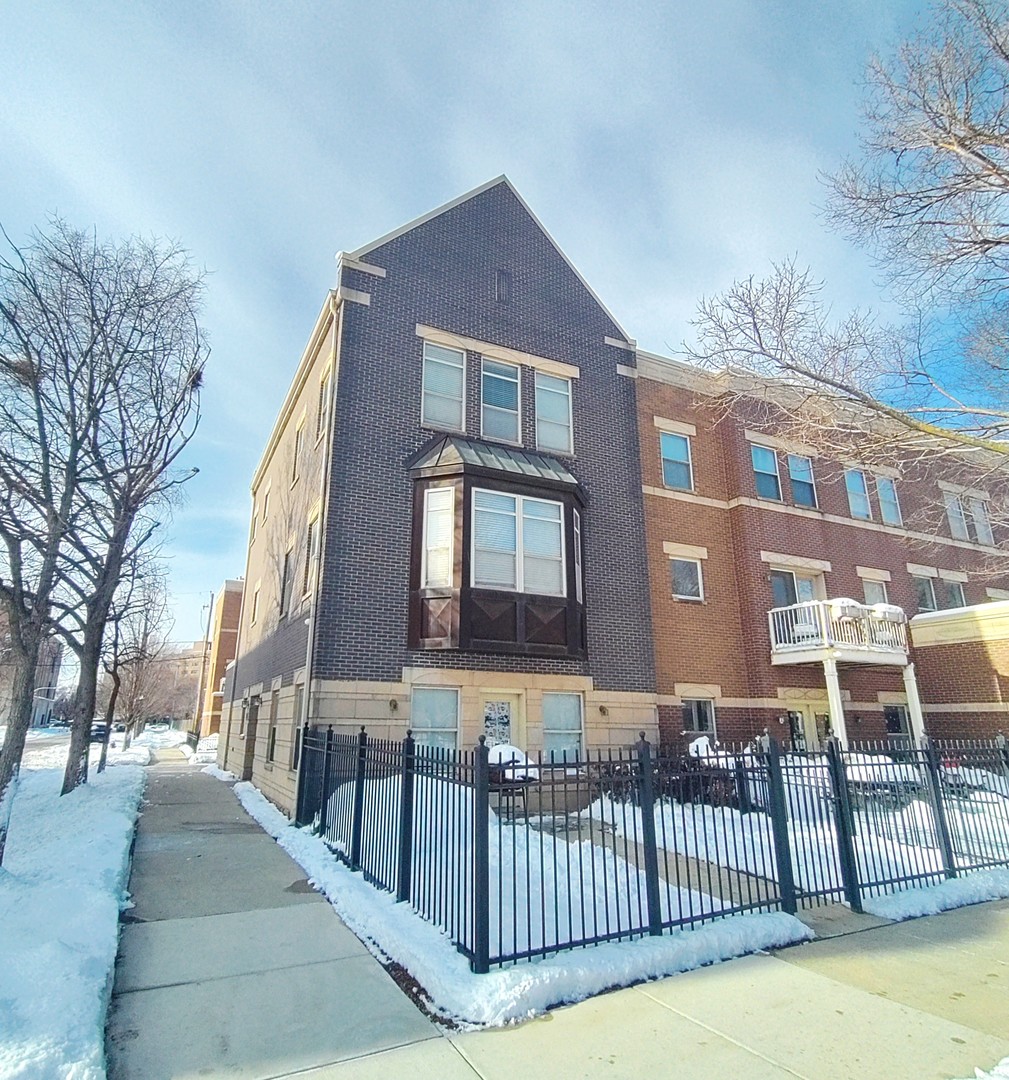 a view of a brick house with many windows