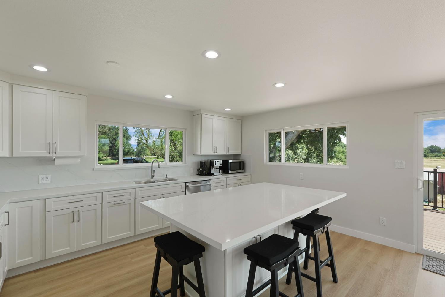 2650 West Twitchell Island Road Rio Vista, CA 94571 - Photo 34 of 60 a kitchen with stainless steel appliances a table and chairs in it