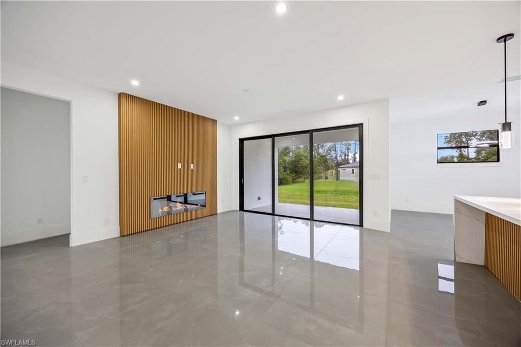 3908 Sunset Road Lehigh Acres, FL 33971 - Photo 7 of 30 a view of an empty room with a sliding door