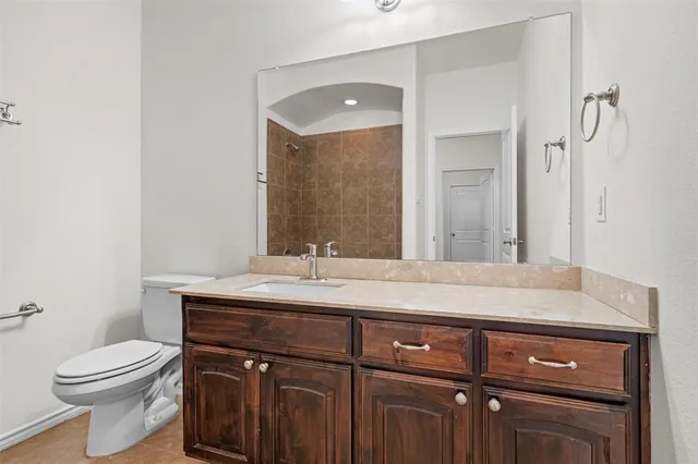 a bathroom with a sink a toilet and vanity