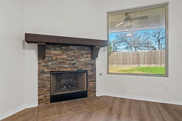 a living room with a fireplace and a window