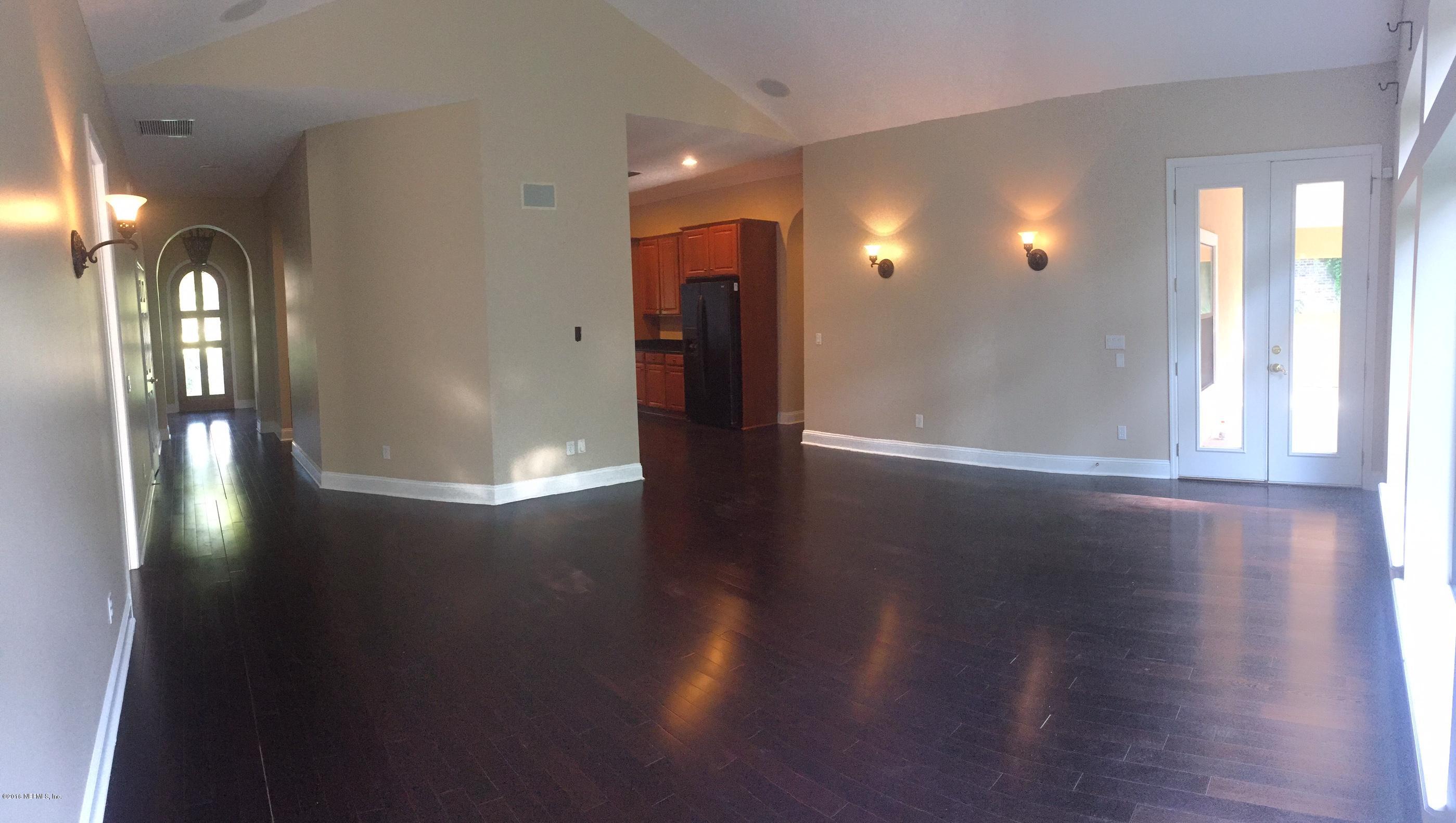 829 Riley Lane St. Augustine, FL 32095 - Photo 6 of 53 a view of a hallway with wooden floor