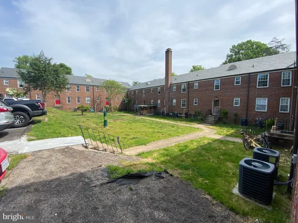 a view of a house with a yard and sitting area