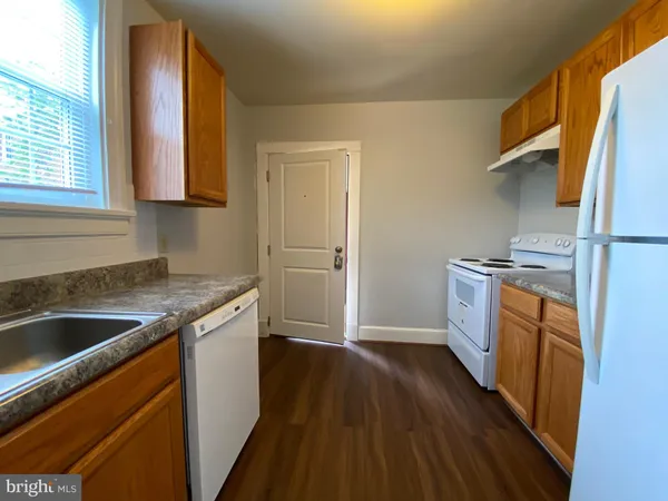 a kitchen with a sink stove and refrigerator