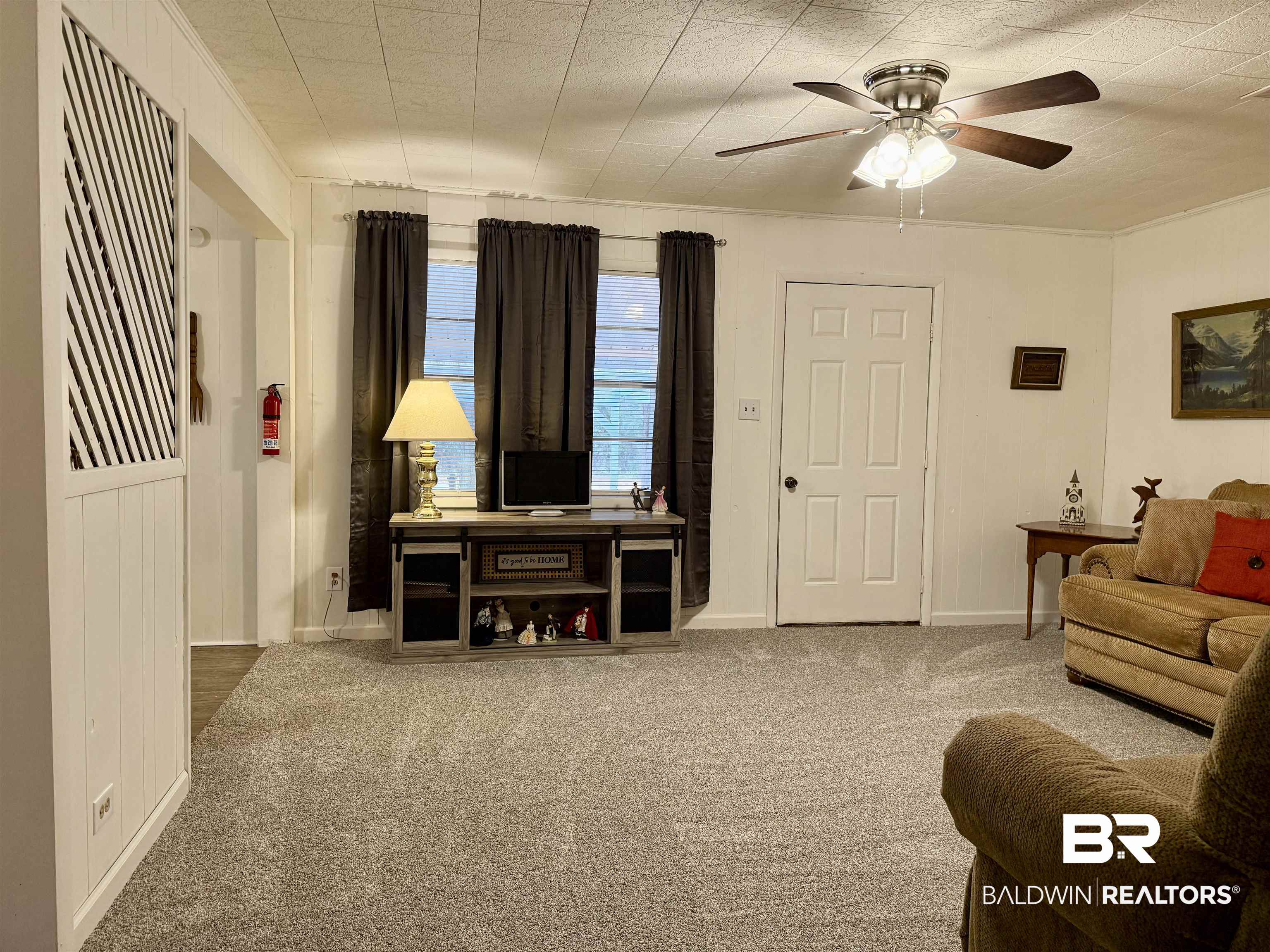 826 West Side Road Castleberry, AL 36432 - Photo 3 of 34 Living room featuring carpet flooring and a ceiling fan