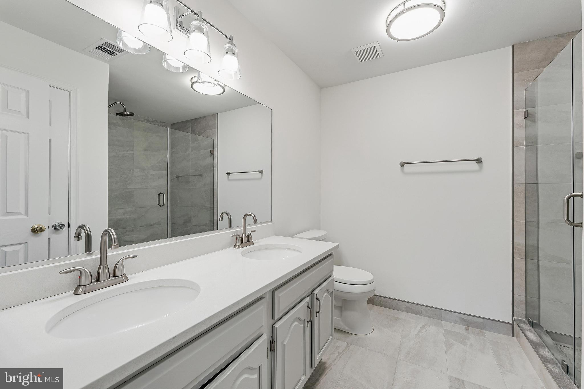 1483 Church Hill Place Reston, VA 20194 - Photo 12 of 38 a bathroom with a sink a toilet a mirror and shower