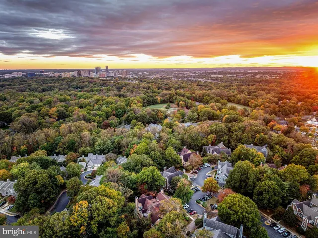 an aerial view of a city with lots of residential buildings and mountain view in back