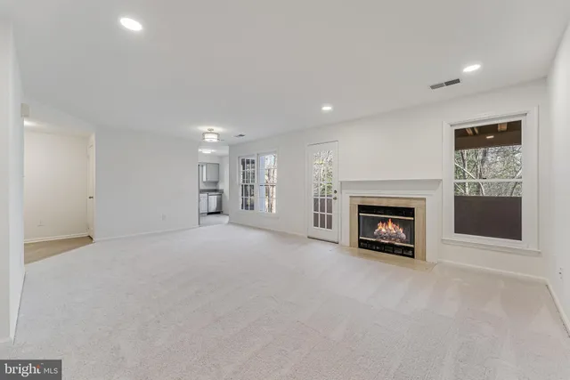 a view of an empty room with a fireplace