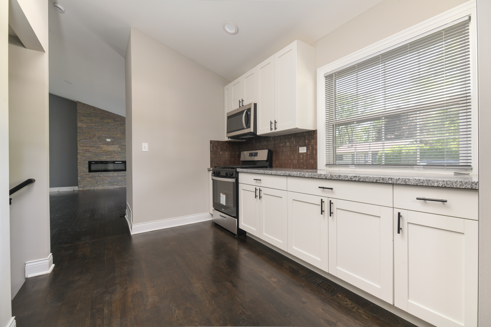 3402 Roesner Drive Markham, IL 60428 - Photo 8 of 23 a kitchen with stainless steel appliances granite countertop a stove a sink and a microwave