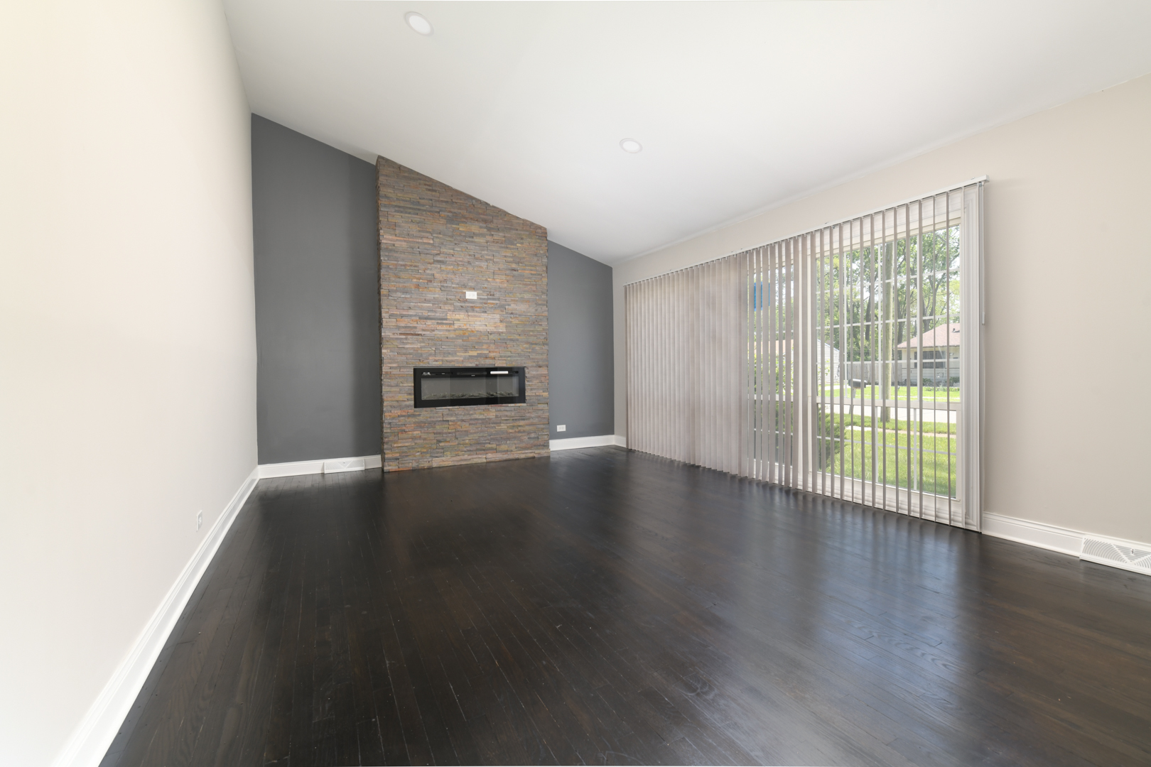 3402 Roesner Drive Markham, IL 60428 - Photo 10 of 23 a view of a livingroom with wooden floor and a fireplace