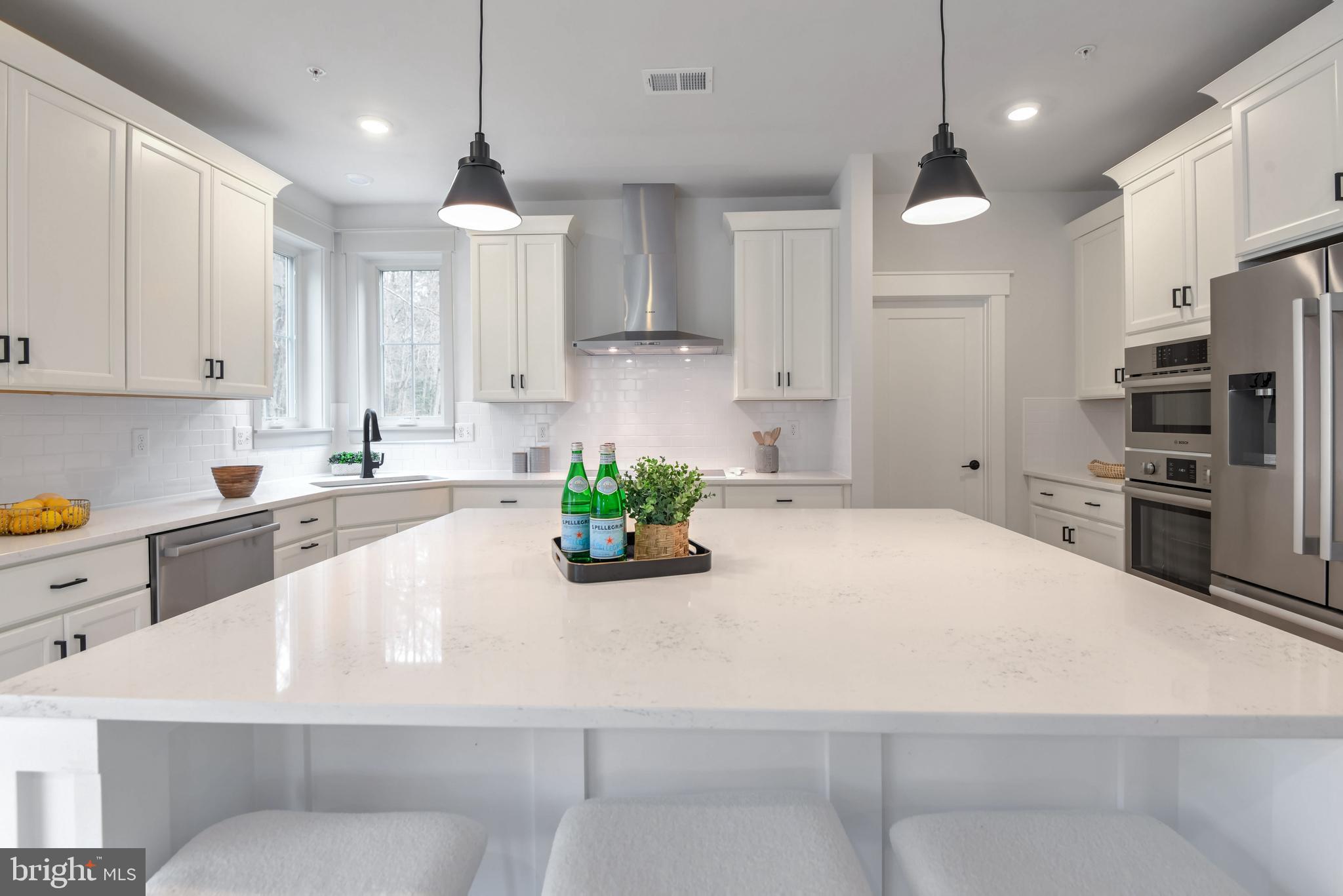 Eliana Court Laurel, MD 20708 - Photo 10 of 46 a kitchen with stainless steel appliances kitchen island granite countertop a sink a stove and cabinets