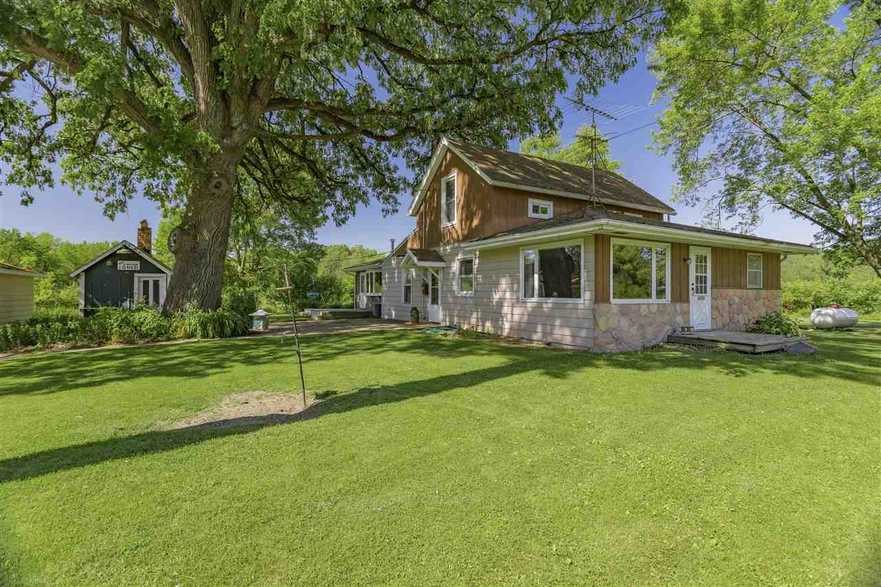 a front view of house with yard and trees