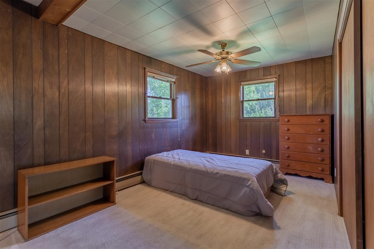 9639 East River Road Ridott, IL 61067 - Photo 13 of 32 a bedroom with a bed and a chandelier