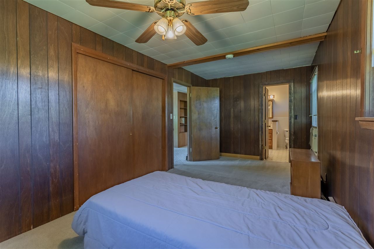 9639 East River Road Ridott, IL 61067 - Photo 14 of 32 a view of hallway with a chandelier fan and a wooden floor
