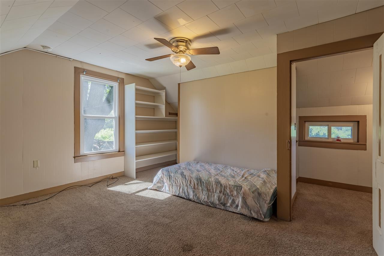 9639 East River Road Ridott, IL 61067 - Photo 18 of 32 a bedroom with a bed and a ceiling fan