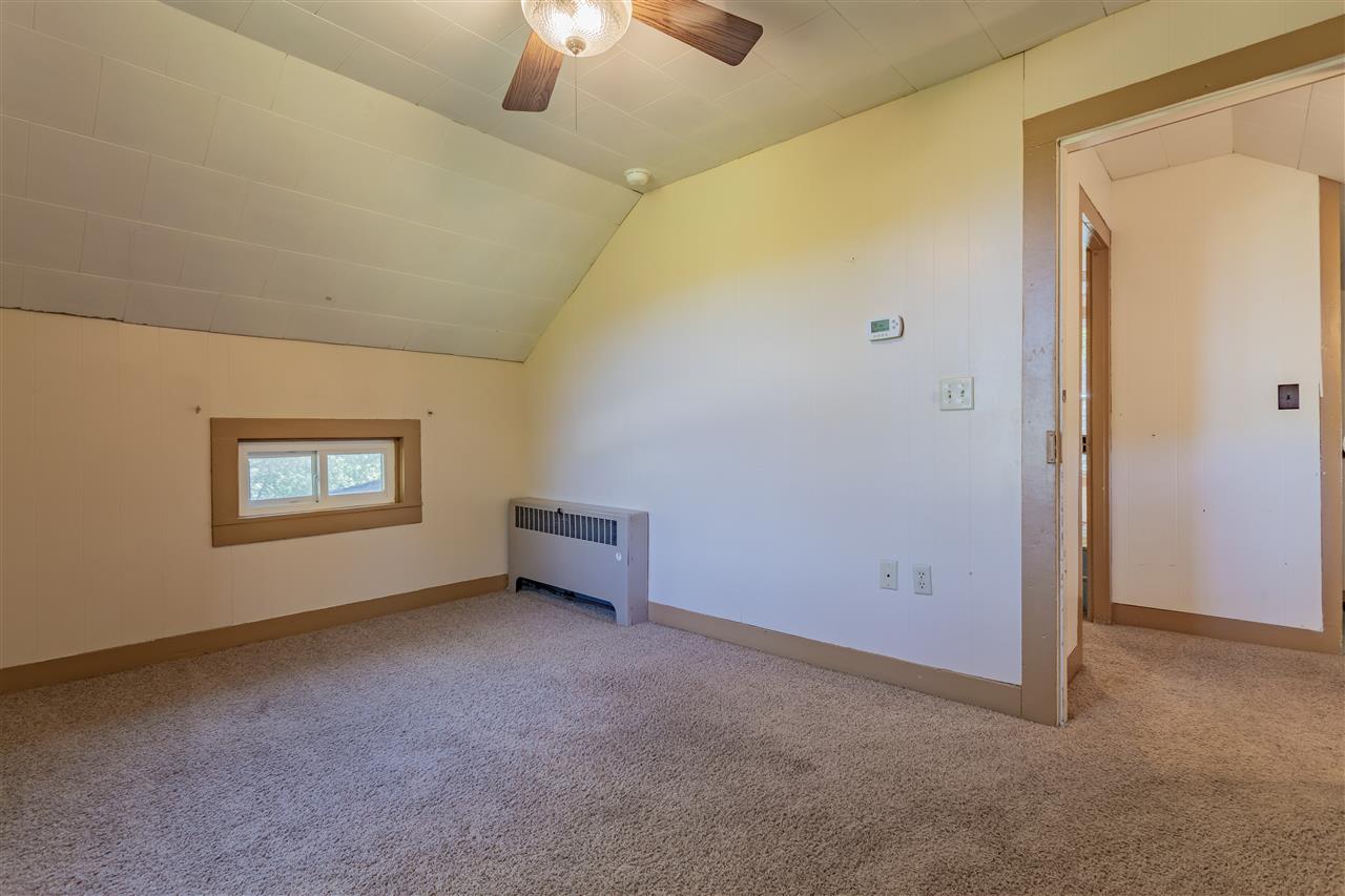 9639 East River Road Ridott, IL 61067 - Photo 22 of 32 an empty room with a empty space and a ceiling fan