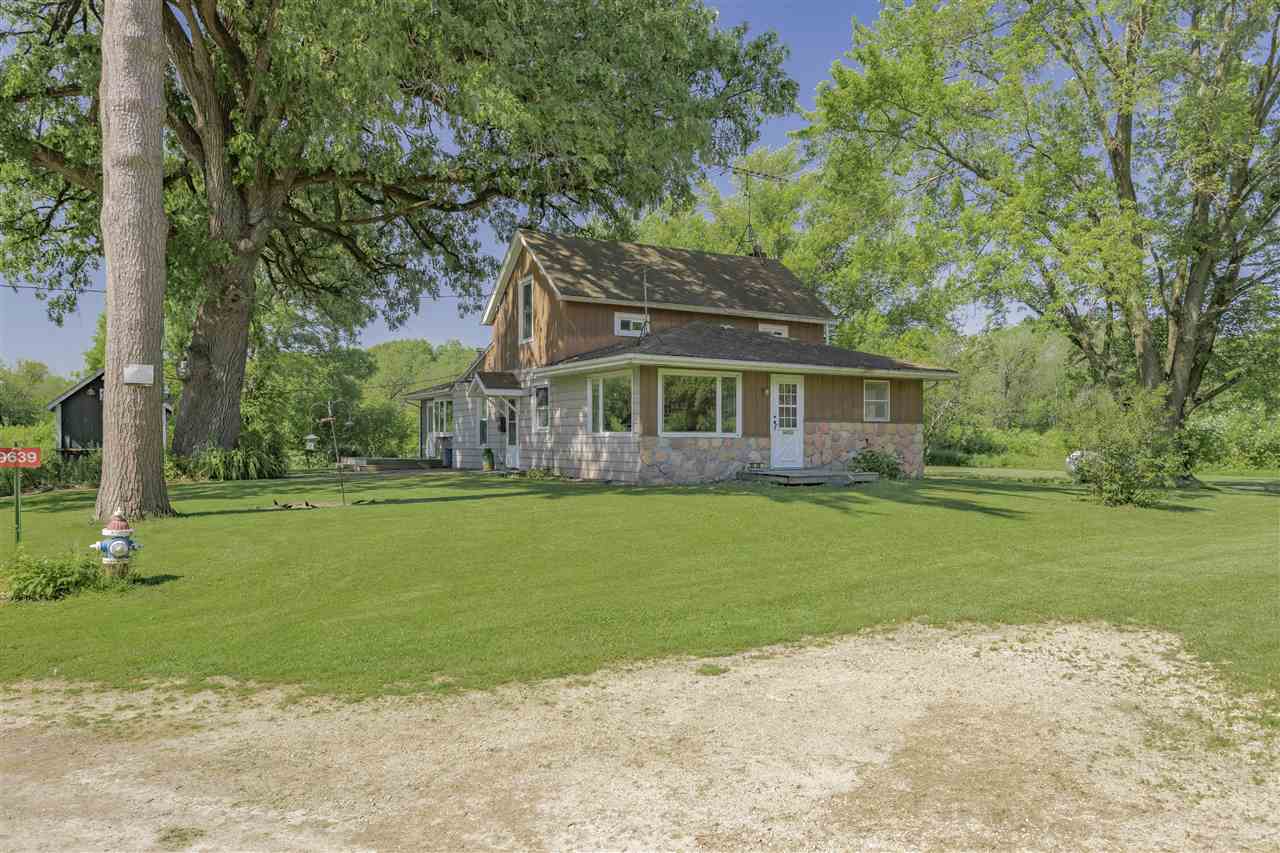 9639 East River Road Ridott, IL 61067 - Photo 23 of 32 a front view of a house with a garden
