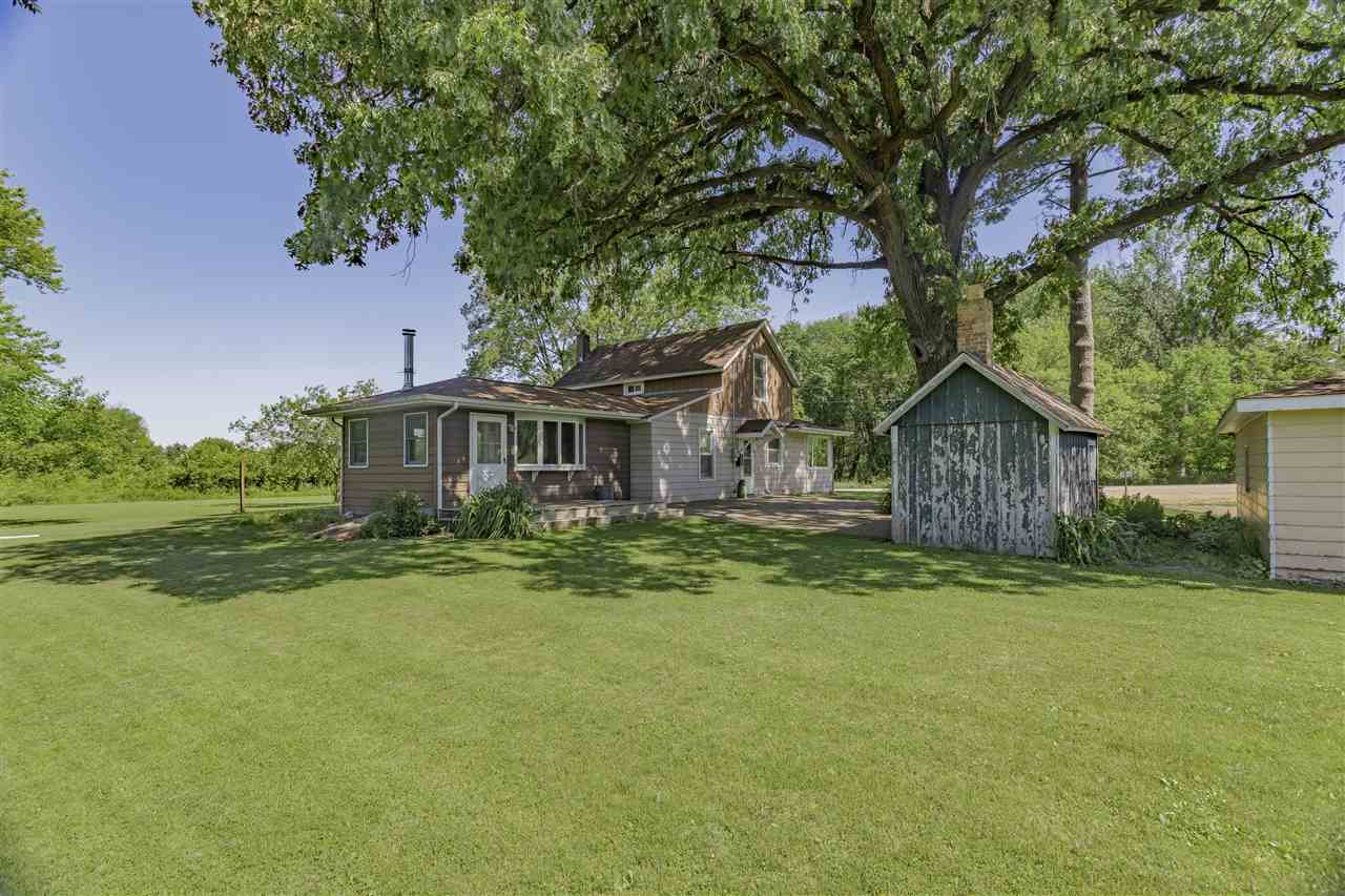 9639 East River Road Ridott, IL 61067 - Photo 25 of 32 a front view of a house with a garden