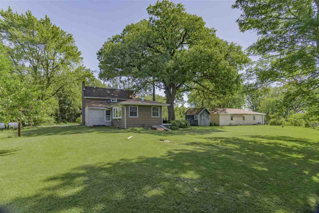 9639 East River Road Ridott, IL 61067 - Photo 26 of 32 a house with a tree in front of it