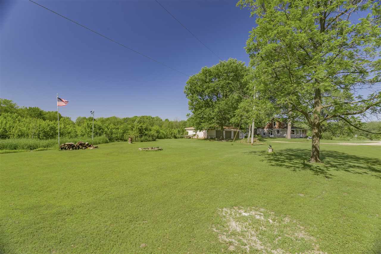 9639 East River Road Ridott, IL 61067 - Photo 29 of 32 a view of a field with trees in the background