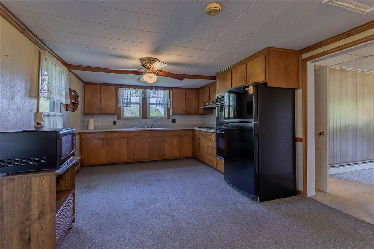 9639 East River Road Ridott, IL 61067 - Photo 7 of 32 a kitchen with stainless steel appliances a refrigerator and a stove top oven