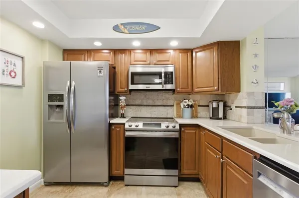 a kitchen with stainless steel appliances granite countertop a sink stove and wooden floor