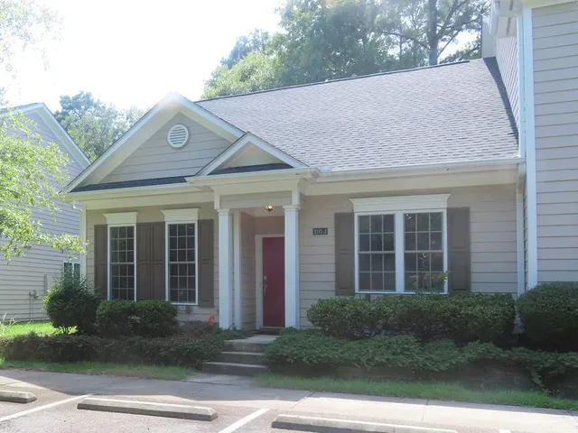 a view of a white house with a outdoor space