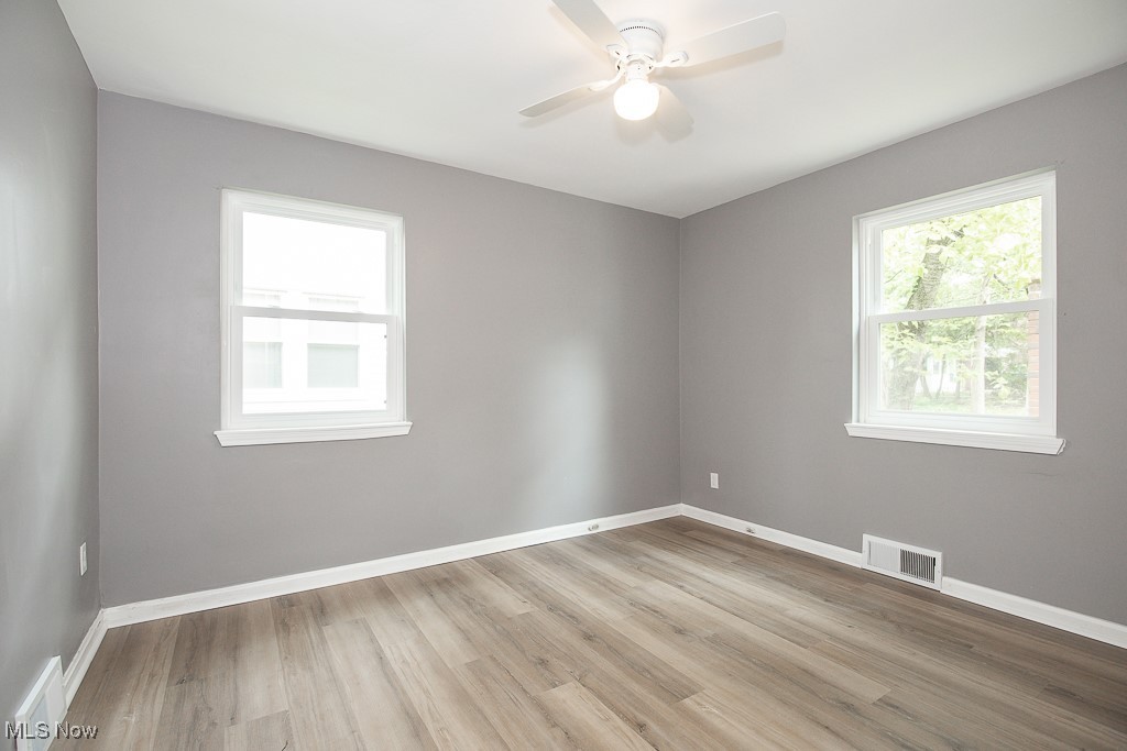 1547 Genesee Road South Euclid, OH 44121 - Photo 10 of 36 Spare room featuring wood finished floors, ceiling fan, and baseboards