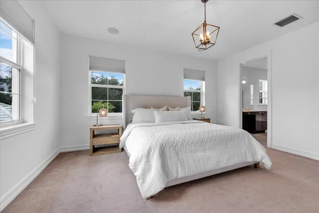 a bedroom with a bed couch and window