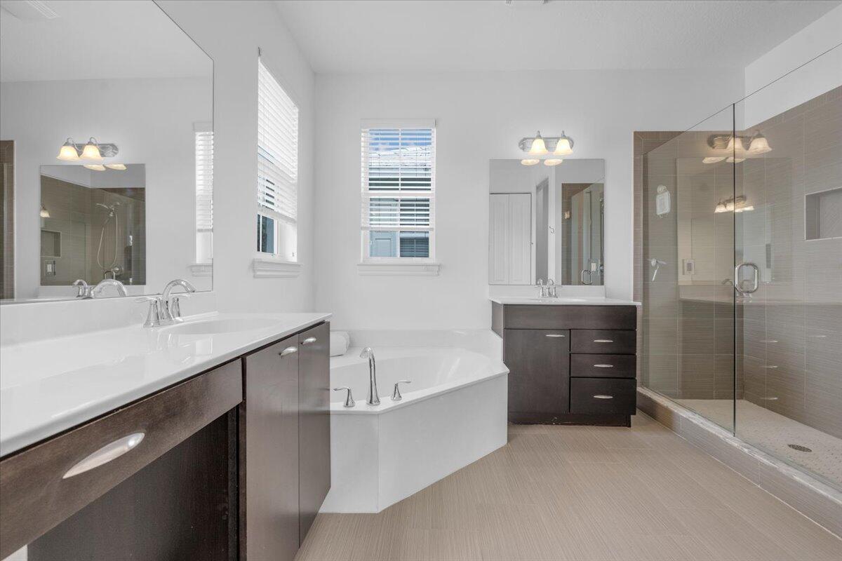 120 West Bay Cedar Circle Jupiter, FL 33458 - Photo 15 of 33 a bathroom with a tub sink shower and mirror