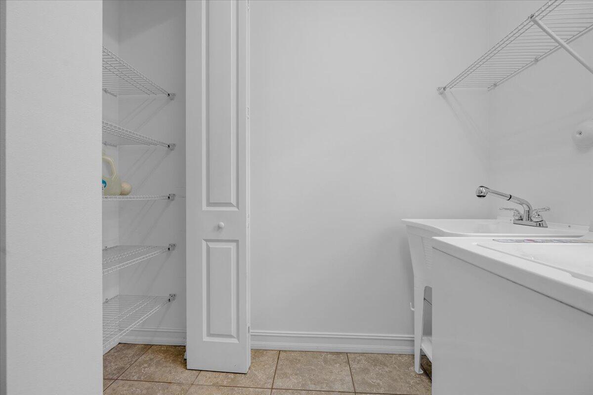 120 West Bay Cedar Circle Jupiter, FL 33458 - Photo 18 of 33 a bathroom with a sink and a mirror