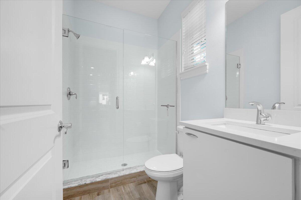 120 West Bay Cedar Circle Jupiter, FL 33458 - Photo 24 of 33 a bathroom with a sink toilet a mirror and shower