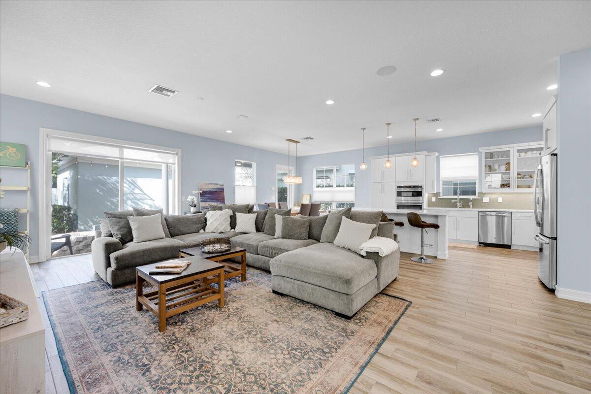 120 West Bay Cedar Circle Jupiter, FL 33458 - Photo 3 of 33 a living room with furniture and view of kitchen